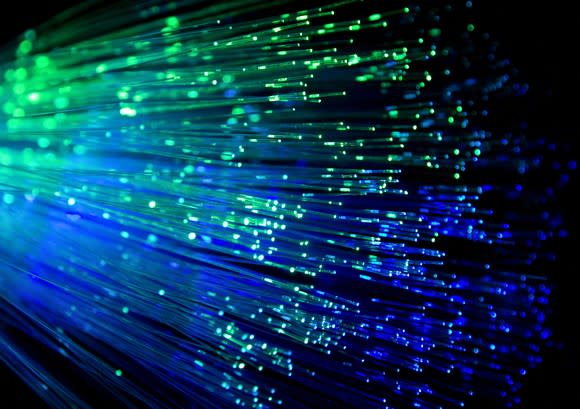 Fiber optic cables with blue and green lights shining through them