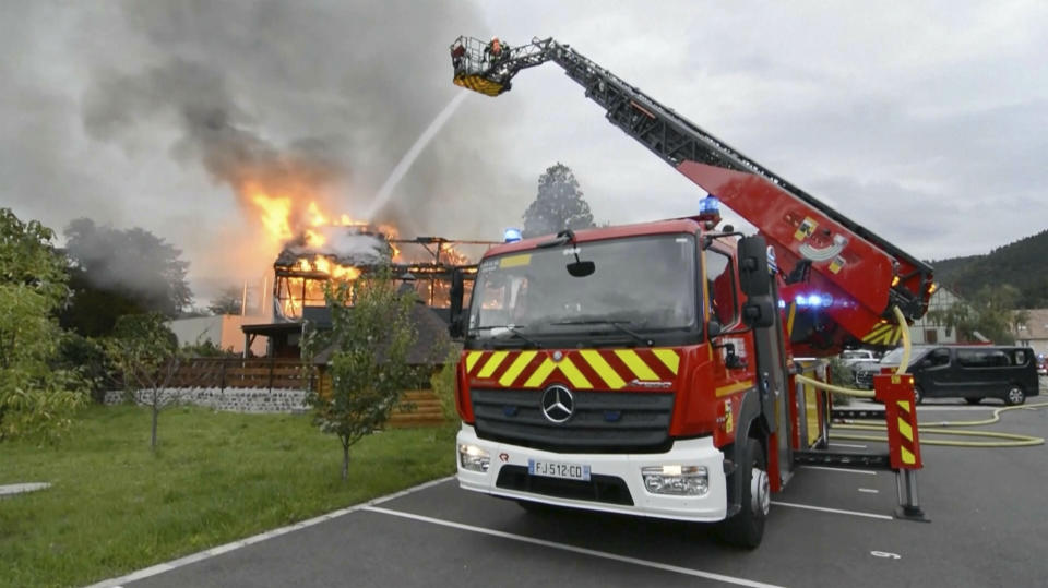 Firefighters try to contain the blaze at a vacation home in the town of Wintzenheim, north-eastern France, Wednesday Aug. 9, 2023. A fire ripped through a vacation home for adults with disabilities in eastern France on Wednesday, killing several people, the head of rescue operations said. (TNN/dpa via AP)