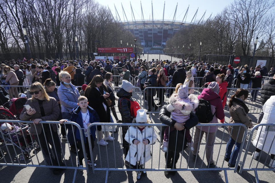Refugees wait in a long line to apply for Polish ID numbers.