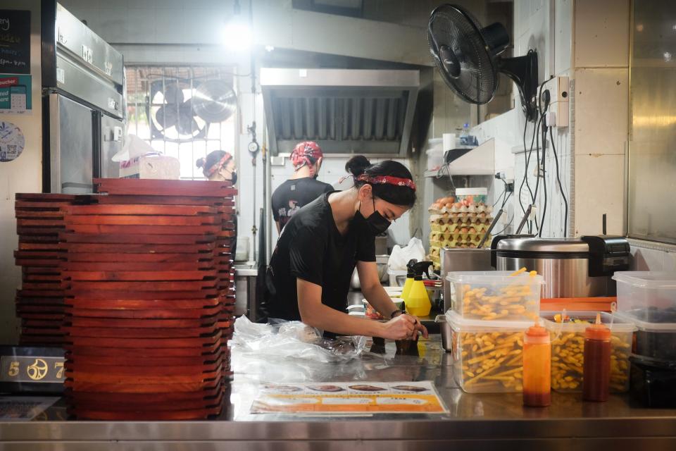 A woman working at a hawker stall