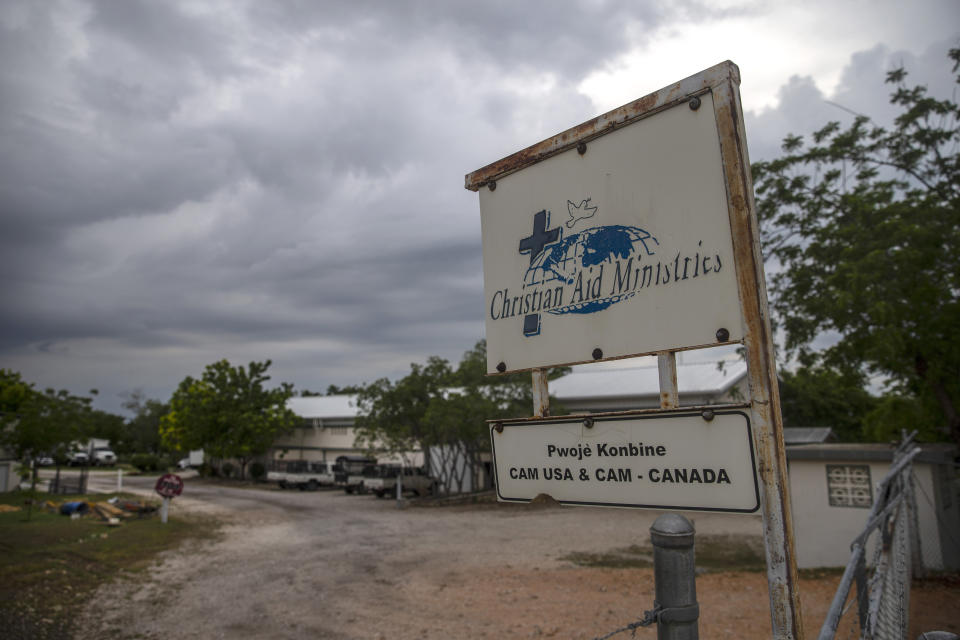 A custom sign stands outside Christian Aid Ministries in Titanyen, north of Port-au-Prince, Haiti, Tuesday, Oct. 19, 2021. A gang kidnapped 17 members of the U.S.-based missionary group on Oct. 16, demanding $1 million ransom per person, although authorities were not clear whether that amount included the five children being held, a top Haitian official said Tuesday. (AP Photo/Joseph Odelyn)