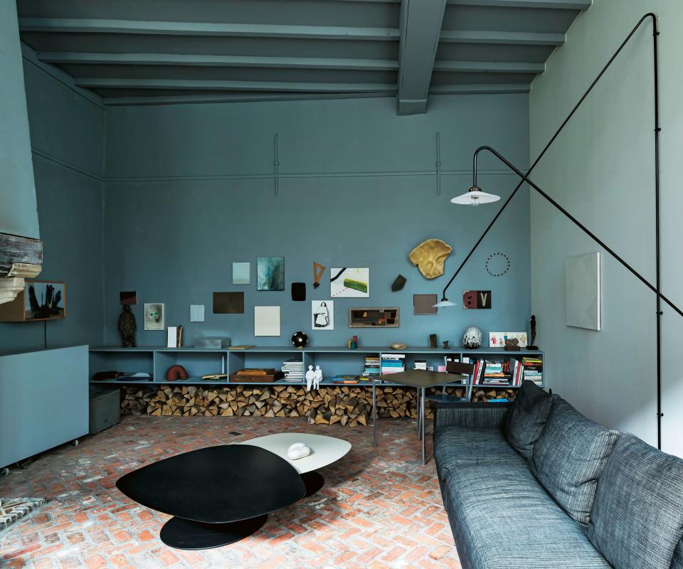 Antwerp gallerist Veerle Wenes channels a respect for cross-pollination in her live-work space, a 1979 concrete building that is merged with an ancient workshop for nuns. “All aspects of my life are connected, and I want to live and work in the same place and show people that art and design can be part of daily life,” she says. In the living room, the wall displays artwork collected over time and serves as a backdrop for lamps by Muller Van Severen.