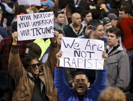 Demonstrators hold signs and cheer after Republican U.S. presidential candidate Donald Trump cancelled his rally at the University of Illinois at Chicago March 11, 2016. REUTERS/Kamil Krzaczynski