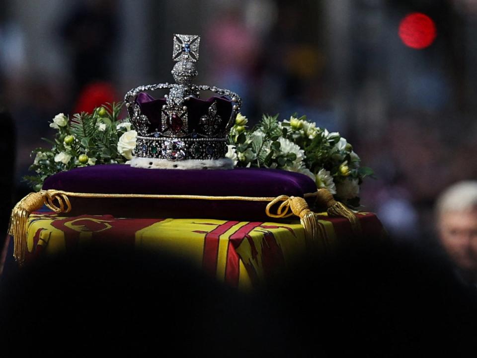 The coffin of Queen Elizabeth II, adorned with a Royal Standard and the Imperial State Crown is pulled by a Gun Carriage of The King’s Troop Royal Horse Artillery (POOL/AFP via Getty Images)