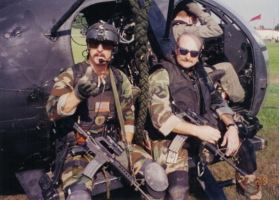 Dan Schilling, left, sits on the side of an MH-6 Little Bird helicopter while training for attacking urban targets at Fort Bragg, North Carolina, in 1994. | Courtesy of Dan Schilling