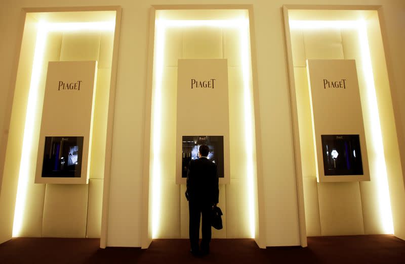 FILE PHOTO: A visitor looks at watches on the Piaget booth SIHH exhibition at the Palexpo in Geneva