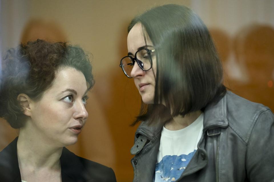 Theater director Zhenya Berkovich, left, and playwright Svetlana Petriychuk are seen in a glass cage prior to a hearing in a court in Moscow, Russia, Monday, May 20, 2024. Berkovich, a prominent independent theater director, and Petriychuk, a playwright have been behind bars since early May. Authorities claim a play they staged, "Finist, the Brave Falcon," justifies terrorism, which is a criminal offence in Russia punishable by up to seven years in prison. (AP Photo/Dmitry Serebryakov)