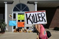 Protesters call attention to the alleged poaching of Cecil the lion, in the parking lot of Dr. Walter Palmer's River Bluff Dental Clinic on July 29, 2015 in Bloomington, Minnesota