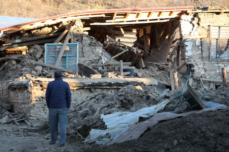 A villager looks at his collapsed house after an earthquake in Sivrice near Elazig