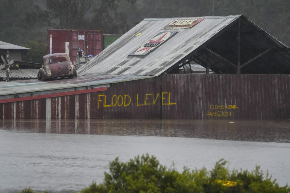 Flood waters surround an industrial property in Londonderry on the outskirts of Sydney, Australia, Monday, July 4, 2022. More than 30,000 residents of Sydney and its surrounds have been told to evacuate or prepare to abandon their homes on Monday as Australia's largest city braces for what could be its worst flooding in 18 months. (AP Photo/Mark Baker)