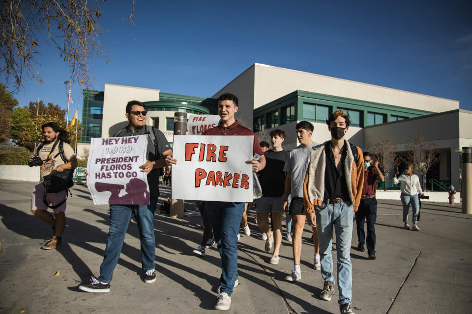 Arts and Sciences ASNMSU Senator Garrett Moseley holds a sign that reads "Fire Parker" while students march through New Mexico State campus in Las Cruces demanding the university fire President John Floros and Provost Carol Parker on Tuesday, Nov. 16, 2021.