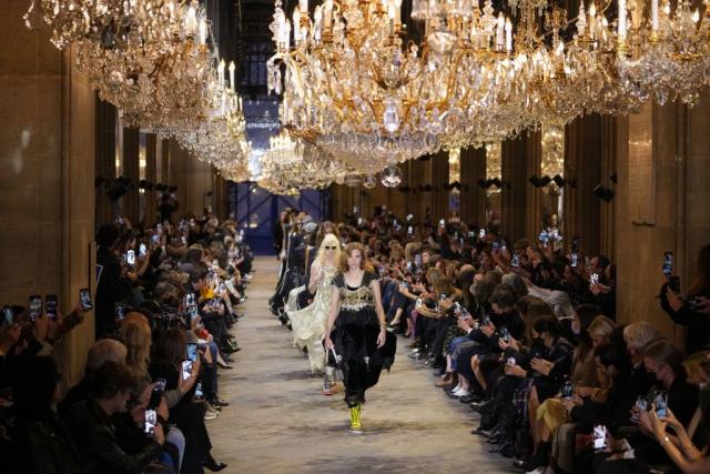 Protestor on Louis Vuitton SS22 Runway Show