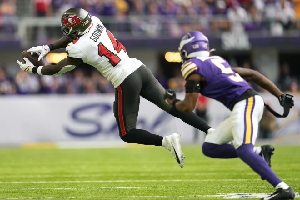 Tampa Bay Buccaneers wide receiver Chris Godwin (14) catches a pass in front of Minnesota Vikings defender Mekhi Blackmon (5) during the second half of an NFL football game, Sunday, Sept. 10, 2023, in Minneapolis. The Buccaneers won 20-17. (AP Photo/Abbie Parr)