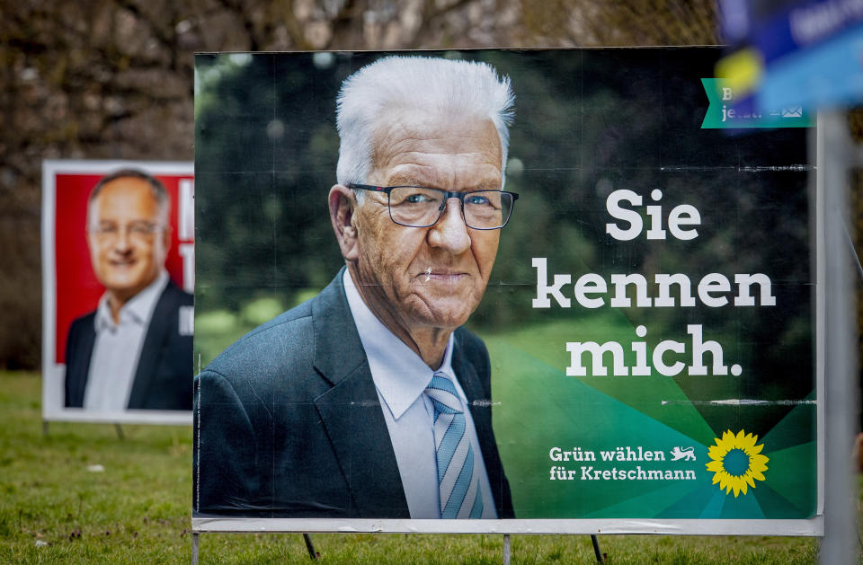 Election posters show Winfried Kretschmann from the Greens and the party's top candidate for the Baden-Wurttemberg federal state elections in Mannheim, Germany, Wednesday, March 10, 2021. The elections will take place next Sunday. Letters on left poster read "edges stabilize", letters on right poster read "you know me". (AP Photo/Michael Probst)