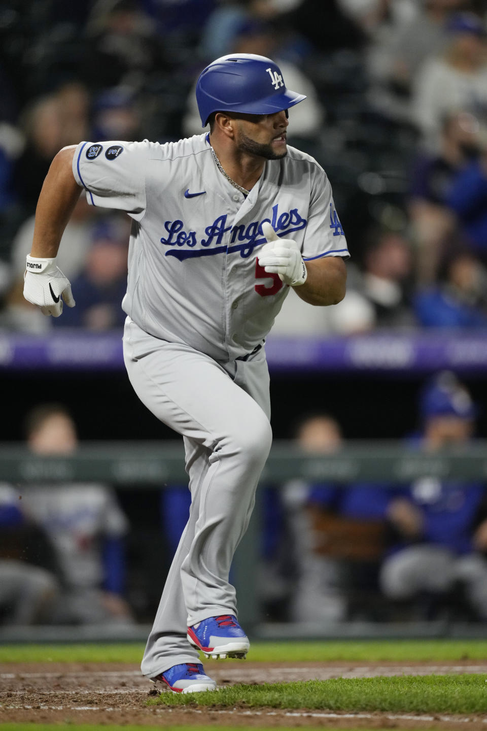 Los Angeles Dodgers pinch-hitter Albert Pujols heads up the first-base line after hitting an RBI-single off Colorado Rockies relief pitcher Jhoulys Chacin in the 10th inning of a baseball game Tuesday, Sept. 21, 2021, in Denver. The Dodgers won 5-4. (AP Photo/David Zalubowski)