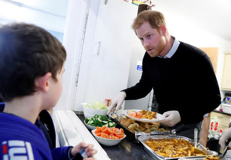 Britain's Prince Harry serves a lunch to children during his visit to a 'Fit and Fed' half-term initiative in London, Britain February 19, 2019. Chris Jackson/Pool via REUTERS