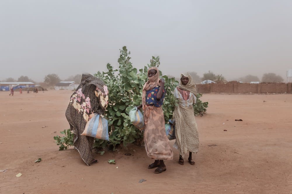 Women cover themselves with shawls while a sandstorm ravages the Adrè refugee camp. Without proper sanitation and open defecation as a common practice, the wind raises and scatters waste across the camp.<span class="copyright">Nicolò Filippo Rosso</span>