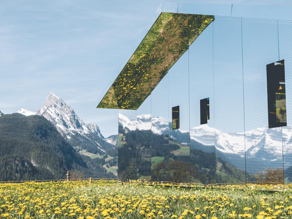 The Swiss Alps are reflected on Mirage Gstaad by artist Doug Aitken.