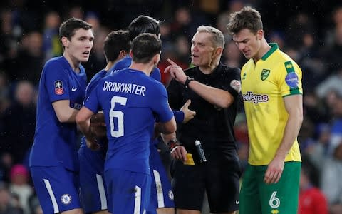 Danny Drinkwater, Alvaro Morata and Andreas Christensen react after Willian is shown a yellow card for simulation by referee Graham Scott  - Credit: Reuters