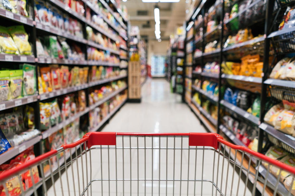 The end of a shopping cart being pushed in a grocery store