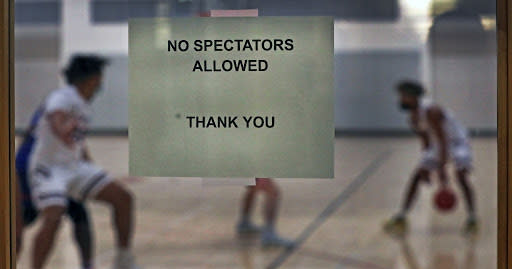 CONCORD, MA – JANUARY 5: A sign on the gymnasium door reads “No Spectators Allowed, Thank You” during a high school basketball game opener with Newton South and Concord-Carlilse in Concord, MA on Jan. 5, 2021. (Photo by Jim Davis/The Boston Globe via Getty Images)