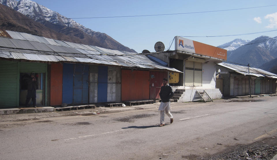 A Pakistani Kashmiri walks through the closed market following the intense exchange of fire between Pakistan and India at border town of Chakoti at the Line of Control in Pakistani Kashmir, Wednesday, Feb. 27, 2019. Pakistan's air force shot down two Indian warplanes after they crossed the boundary between the two nuclear-armed rivals in the disputed territory of Kashmir on Wednesday and captured one Indian pilot, a military spokesman said. (AP Photo/M.D. Mughal)