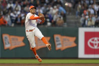 San Francisco Giants shortstop Thairo Estrada throws out Los Angeles Dodgers' Chris Taylor at first base during the sixth inning of a baseball game in San Francisco, Tuesday, July 27, 2021. (AP Photo/Jeff Chiu)