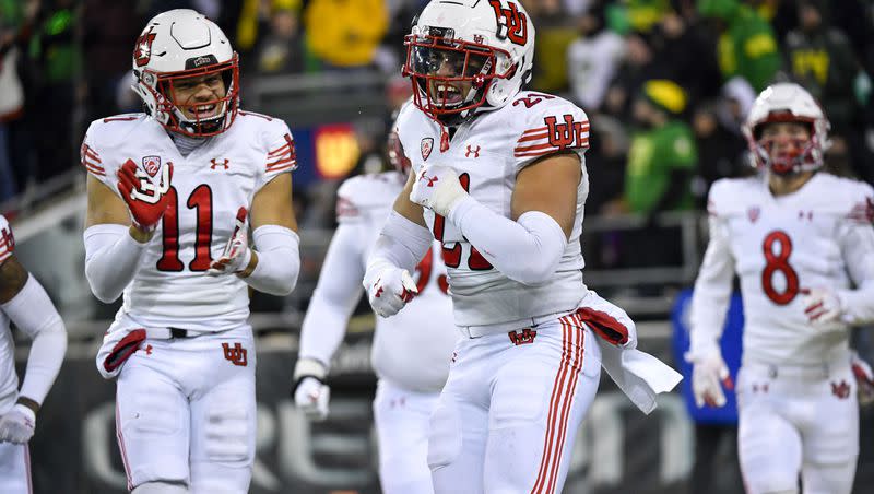 Utah linebacker Karene Reid (21) celebrates his fumble return touchdown against Oregon with safety R.J. Hubert (11) Saturday, Nov. 19, 2022, in Eugene, Ore. 