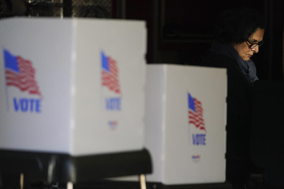 Kimberly Battista fills out a digital ballot while casting her vote at the Baltimore City Fire Department's engine house #5, Tuesday, Nov. 8, 2022, in Baltimore. (AP Photo/Julio Cortez)