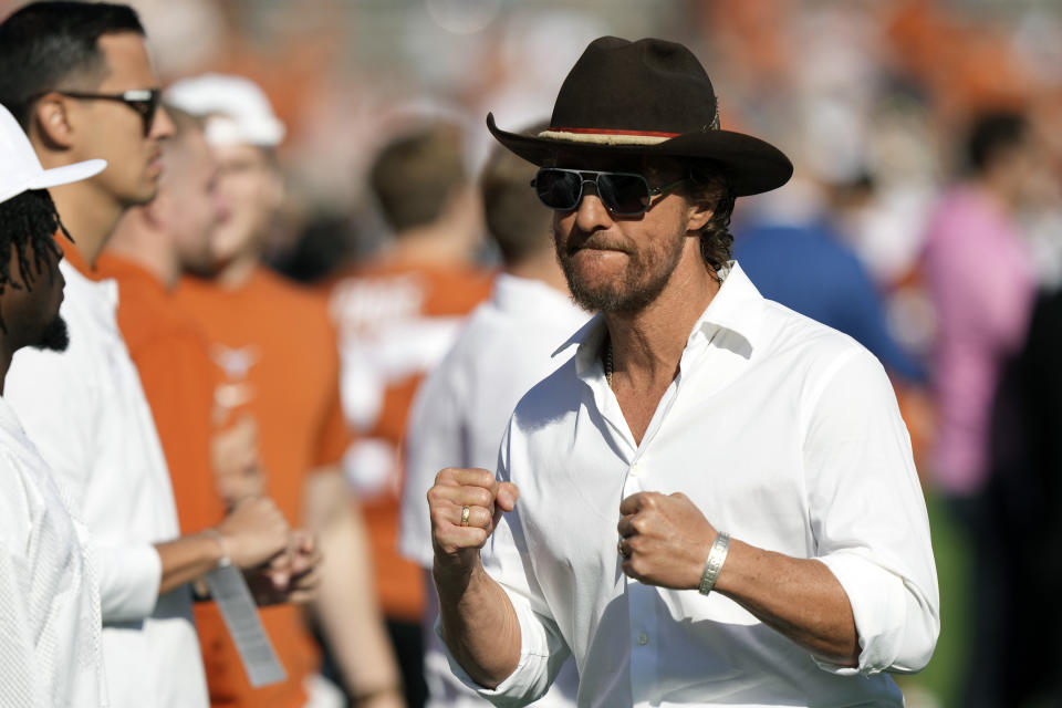 Actor Matthew McConaughey stands on the field during warmups before an NCAA college football game between Oklahoma and Texas at the Cotton Bowl in Dallas, Saturday, Oct. 7, 2023. (AP Photo/LM Otero)