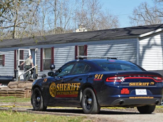 Investigators work at the scene of the shooting in Ascension parish in Louisiana (Hilary Scheinuk/The Advocate via AP)