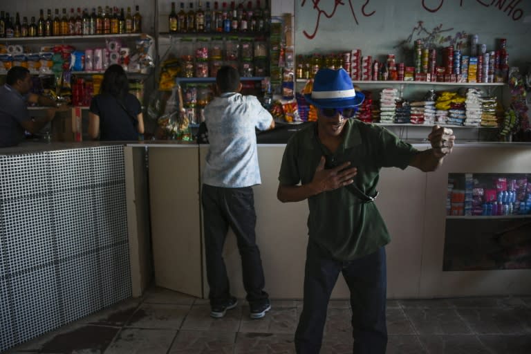 A man dances at a convenience store in Rio's Santa Marta favela