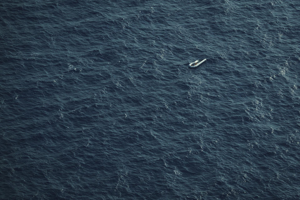 A partially deflated and empty rubber boat, probably used by migrants, floats in the Mediterranean Sea between Libya and Italy, on Monday, Oct. 4, 2021, as seen from aboard the humanitarian aircraft Seabird. At least 23,000 people have died or disappeared trying to reach Europe since 2014, according to the United Nations' migration agency. Despite the risks, many migrants say they'd rather die trying to reach Europe than be returned to Libya. (AP Photo/Renata Brito)