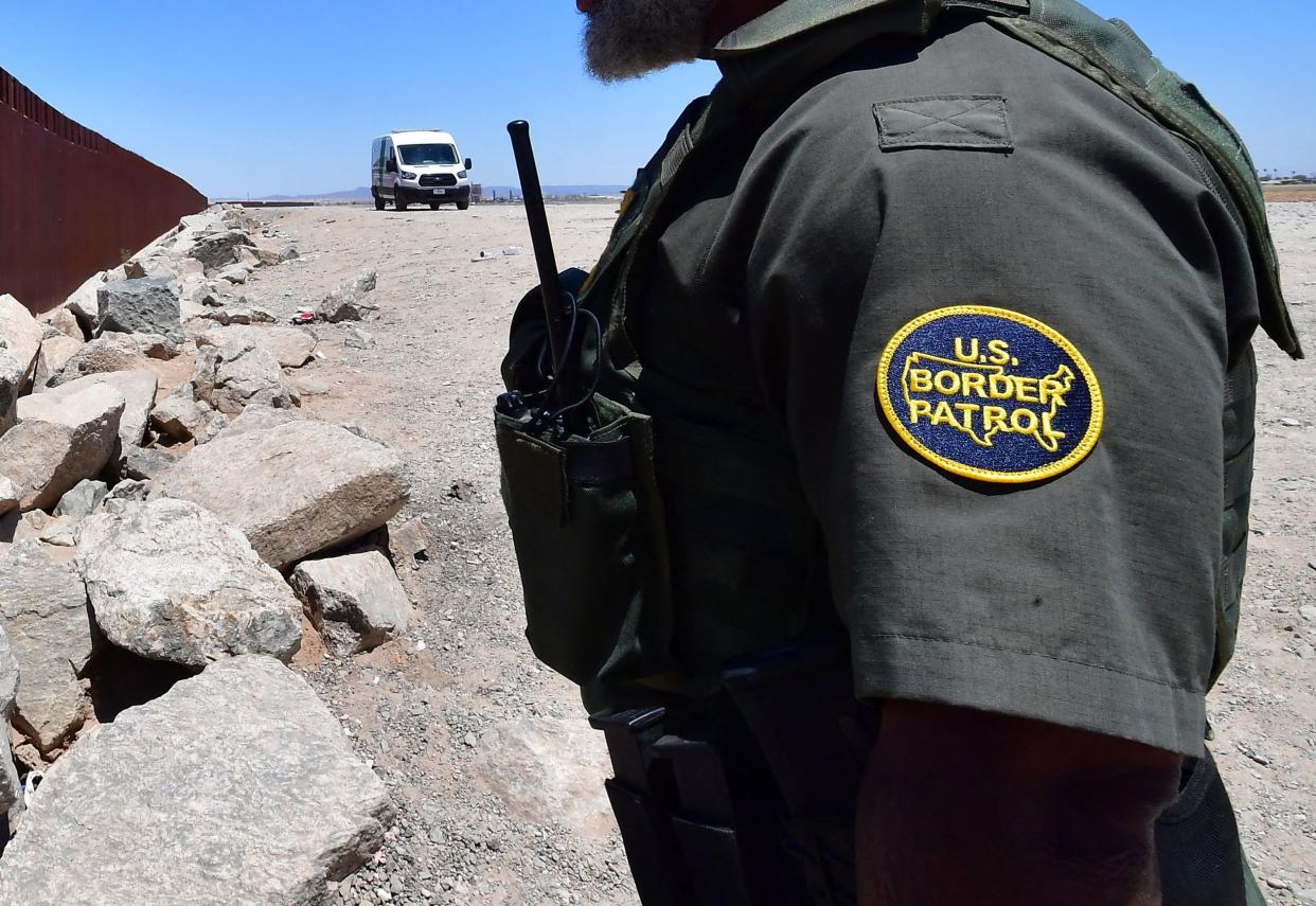 A US Border Patrol officer stands guard at a gap in the border wall separating Algodones, Mexico, from Yuma, Arizona, on May 16, 2022. 