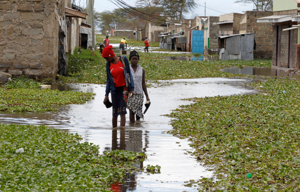 Residents wade through floodwater in a Kenyan town.