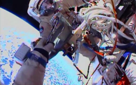 Cosmonauts Oleg Kotov, Expedition 38 commander, and flight engineer Sergey Ryazanskiy perform a spacewalk outside the International Space Station on Dec. 27, 2013. One of the cosmonauts is visible in this view from the other's spacesuit helmet