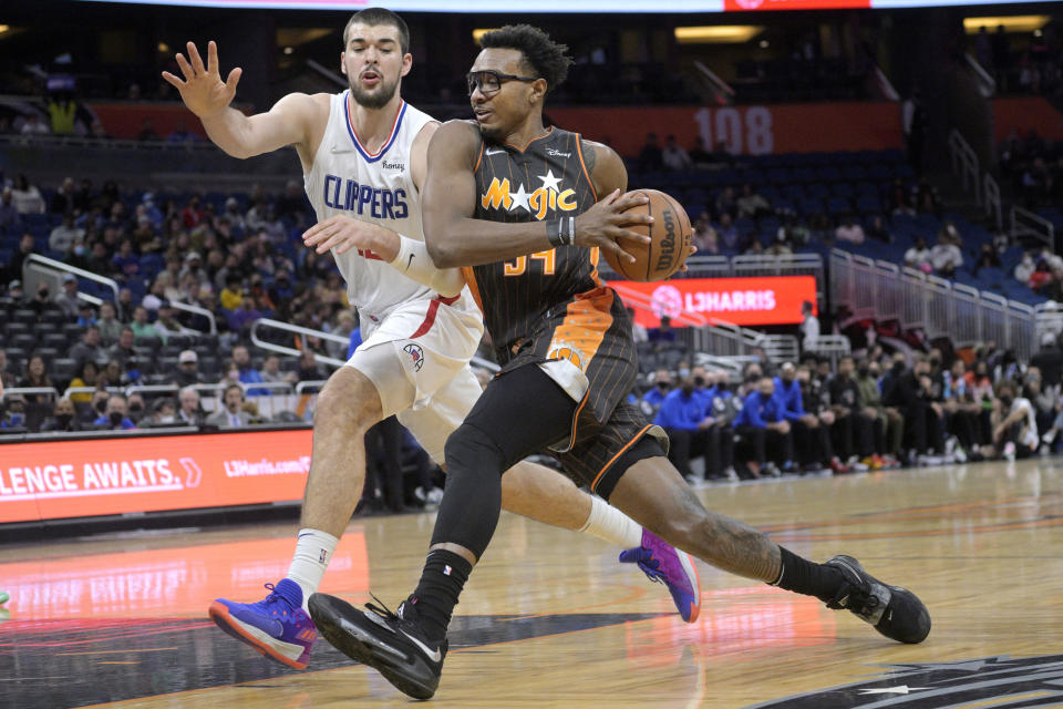 Orlando Magic center Wendell Carter Jr. (34) drives to the basket in front of Los Angeles Clippers center Ivica Zubac, left, during the first half of an NBA basketball game, Wednesday, Jan. 26, 2022, in Orlando, Fla. (AP Photo/Phelan M. Ebenhack)