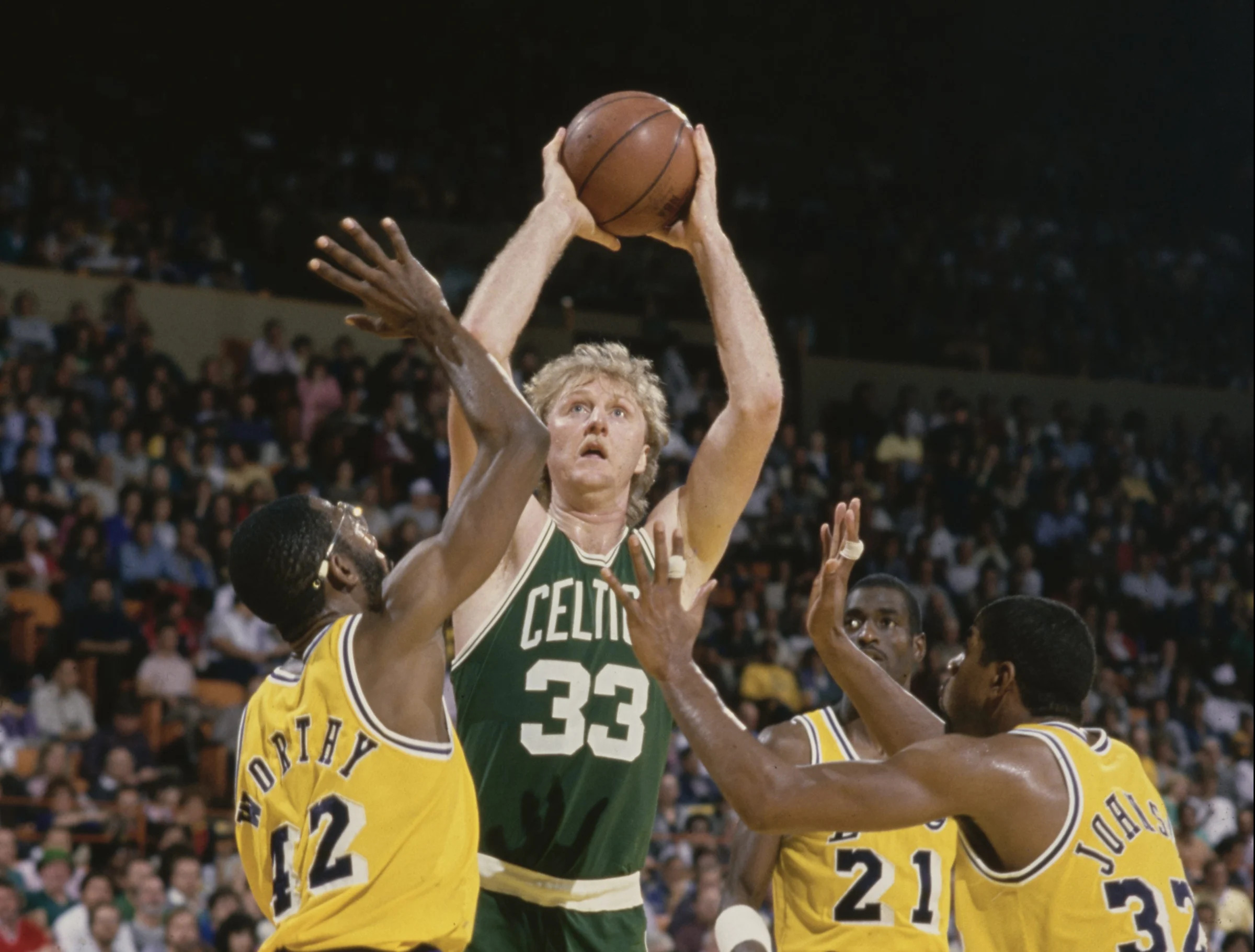 Larry Bird #33, Power Forward for the Boston Celtics prepares to shoot for the basket as James Worthy #42 and Magic Johnson #32 of the Los Angeles Lakers attempt to block during their NBA Pacific Division basketball game on 16th February 1986 at The Forum arena in Inglewood, Los Angeles, California, United States. The Celtics won the game 105 - 99. (Photo by Rick Stewart/Allsport/Getty Images)