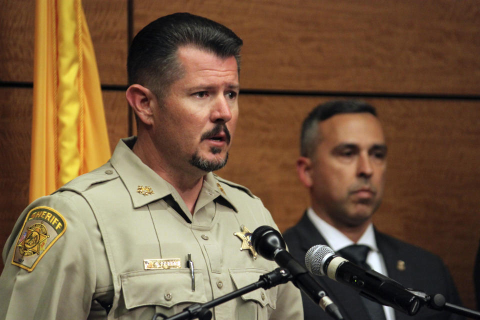 San Juan County Sheriff Shane Ferrari, left, addresses reporters during a news conference in Farmington, N.M., on Tuesday, May 16, 2023. The gunman who killed several people and wounded others while roaming through his northwestern New Mexico neighborhood and apparently firing at random targets was a local 18-year-old high school student, authorities said Tuesday, noting they were still trying to determine a motive for the attack. (AP Photo/Susan Montoya Bryan)