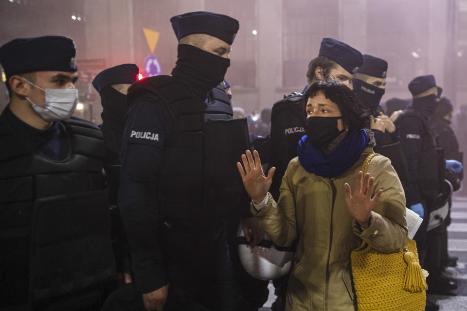 A woman gestures while speaking to riot policemen during a protest against a top court ruling restricting abortions in Warsaw, Poland, Wednesday, Nov. 18, 2020. The upheaval began when the constitutional court, packed with loyalists of the conservative ruling party, ruled Oct. 22 to ban abortions in cases of congenital fetal defects, even if the fetus has no chance of survival. (AP Photo/Agata Grzybowska)