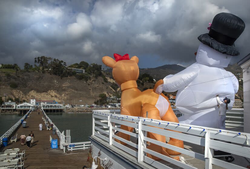 MALIBU, CA-NOVEMBER 28, 2022: A giant inflatable reindeer and snowman are displayed outside Ranch at the Pier, a convenience store located on the Malibu Pier in Malibu. Public health officials issued a cold weather alert for parts of Los Angeles County, where overnight temperatures are expected to drop below freezing today and throughout the week. (Mel Melcon / Los Angeles Times)