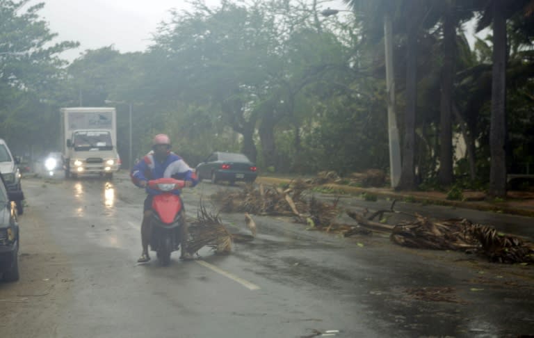 Traffic passes debris left by Tropical Storm Erika on the seafront in Santo Domingo, Dominican Republic on August 28, 2015