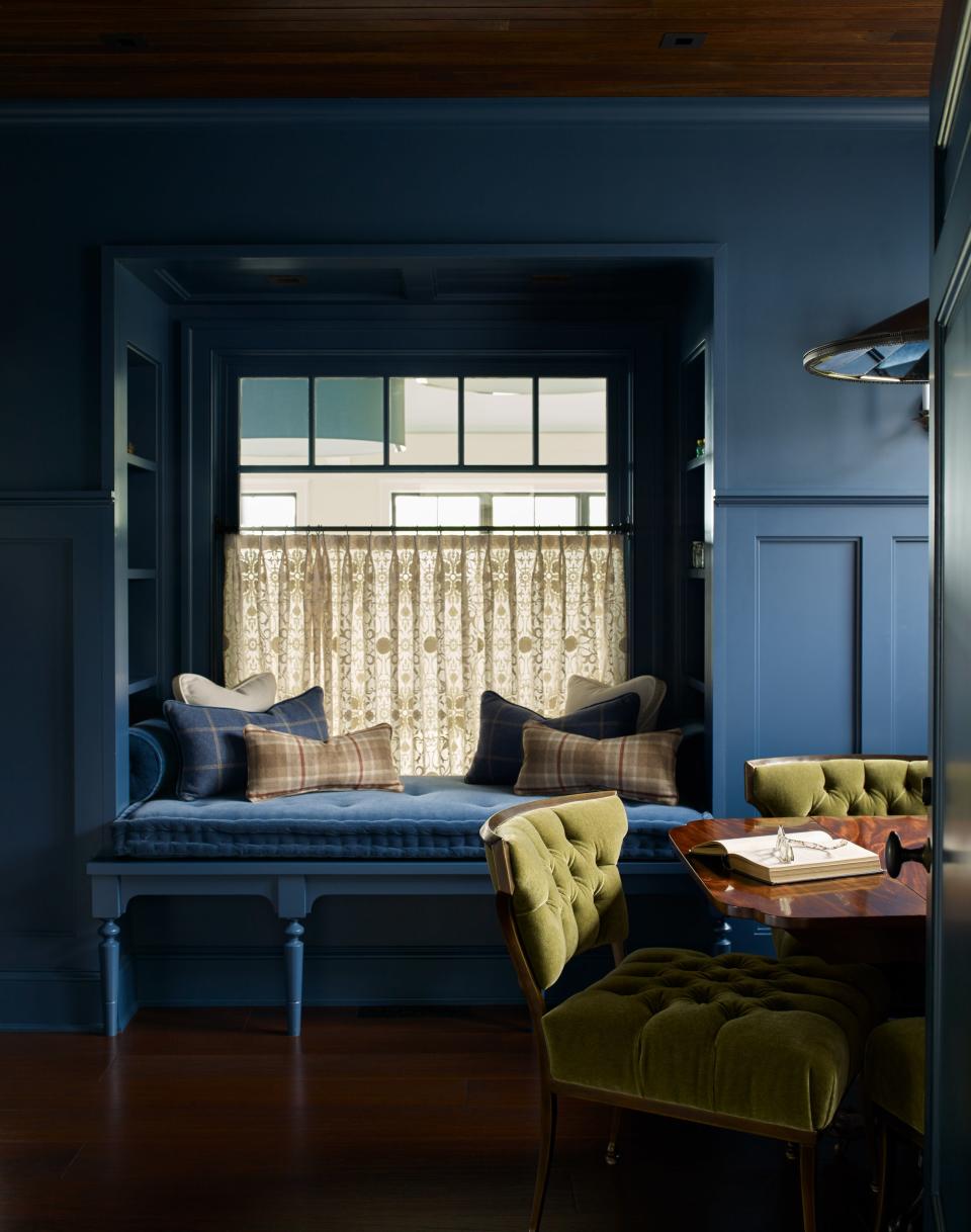 This portion of the study features a built-in bench that’s perfect for curling up with a good mystery book. The Haley chairs by Bernhardt are upholstered in Schumacher green velvet. The room is painted Stiffkey Blue by Farrow & Ball.