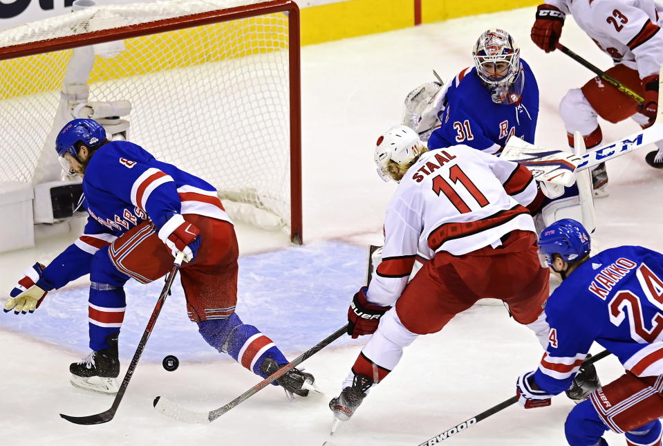 Carolina Hurricanes' Jordan Staal (11) tries to get a shot through New York Rangers' Jacob Trouba (8) and goaltender Igor Shesterkin (31) during second period NHL Eastern Conference Stanley Cup playoff action in Toronto on Tuesday, Aug. 4, 2020. (Frank Gunn/The Canadian Press via AP)