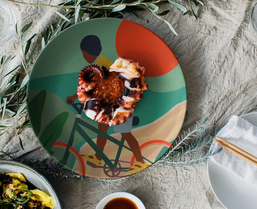 Decorative plate by Domonique Brown features a Black child riding a bicycle. 