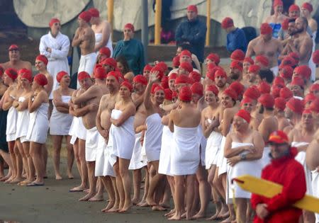 Participants prepare to take part in the Nude Solstice Swim, as part of the Dark Mofo winter festival, in the River Derwent in Hobart, Australia, June 21, 2017. AAP/Rob Blakers/via REUTERS