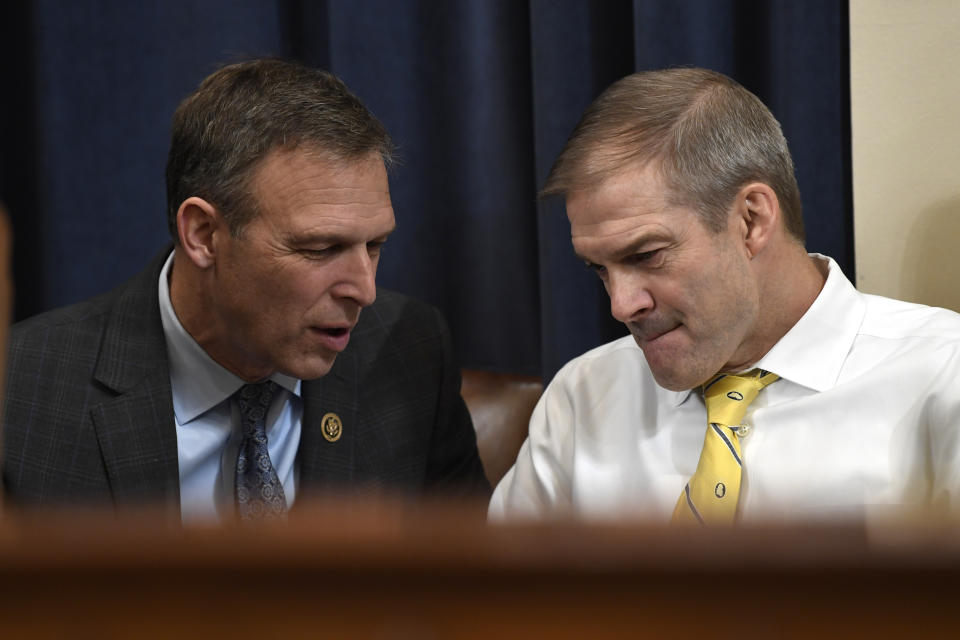 Rep. Scott Perry, R-Pa., talks with Rep. Jim Jordan, R-Ohio, during a break in testimony from former U.S. Ambassador to Ukraine Marie Yovanovitch at the House Intelligence Committee on Capitol Hill in Washington, Friday, Nov. 15, 2019, during the second public impeachment hearing of President Donald Trump's efforts to tie U.S. aid for Ukraine to investigations of his political opponents.(AP Photo/Susan Walsh)