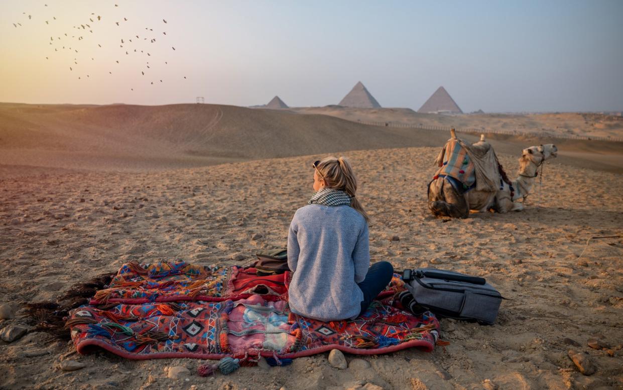 Tourist in front of the Pyramids of Giza in Egypt