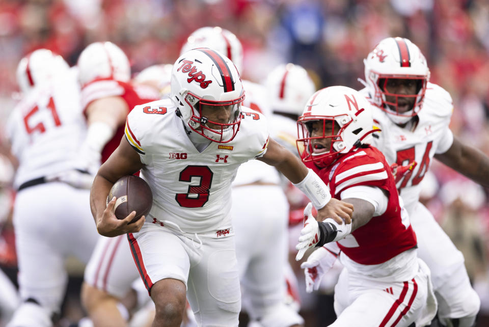 Maryland quarterback Taulia Tagovailoa, left, rushes against Nebraska's Mikai Gbayor during the first half of an NCAA college football game Saturday, Nov. 11, 2023, in Lincoln, Neb. (AP Photo/Rebecca S. Gratz)