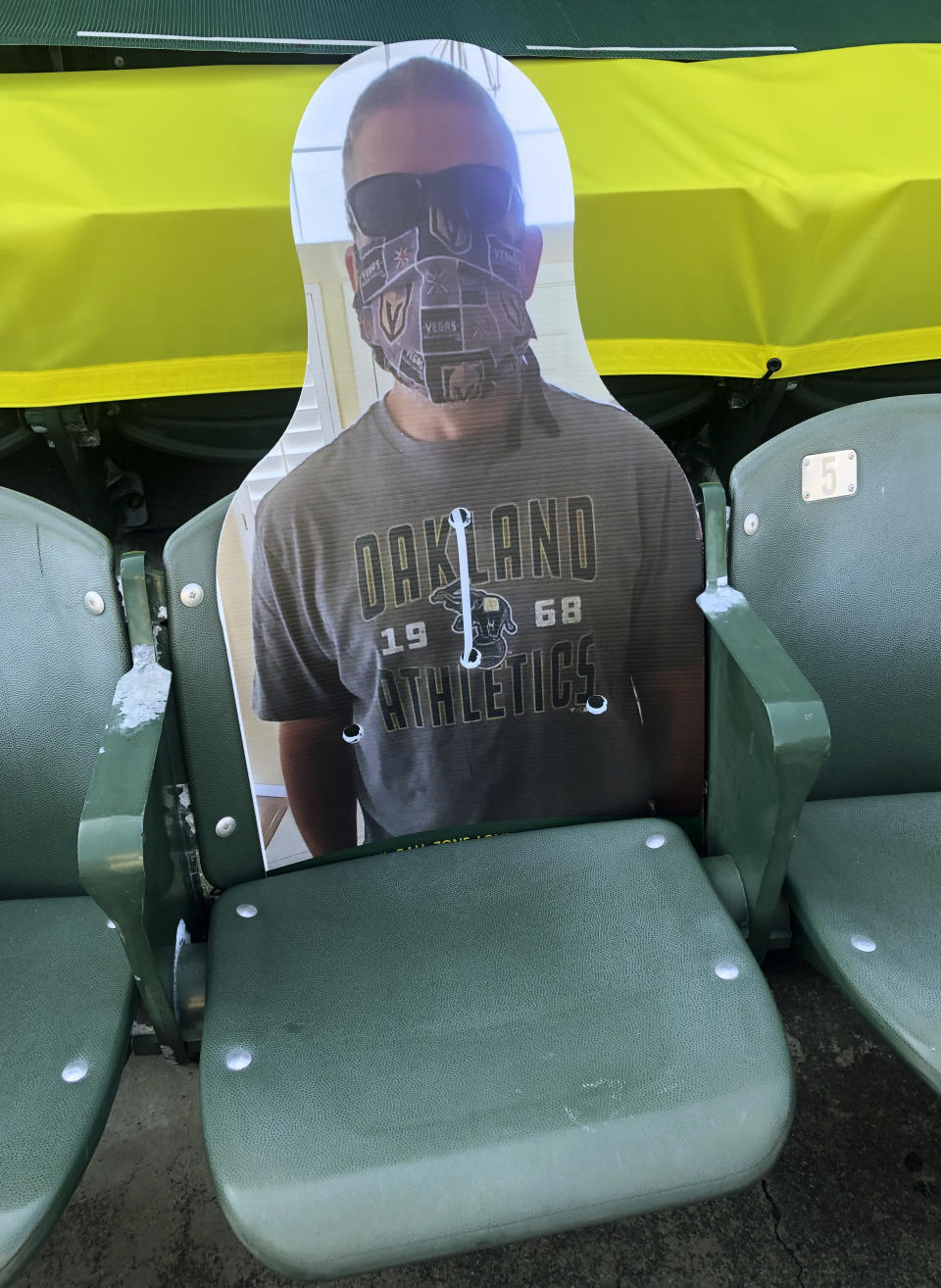 A cardboard cutout depicting A's fan Richard Lovelady of Henderson, Nev., is displayed in a section of the Oakland Coliseum after the baseball game between the Los Angeles Angels and the Oakland Athletics on Monday, July 27, 2020, in Oakland, Calif. An approach taken by some teams is sending out souvenirs to fans if their cardboard cutout gets hit by a ball. The Longtime A's supporter lucked out last Friday night when his cutout — section 126, row 24, seat 4 — was struck by Matt Olson's foul.(AP Photo/Ben Margot)